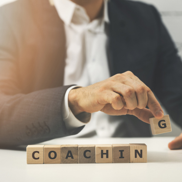 man in suit playing with wooden blocks