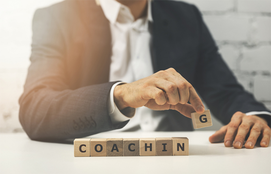 man in suit playing with wooden blocks