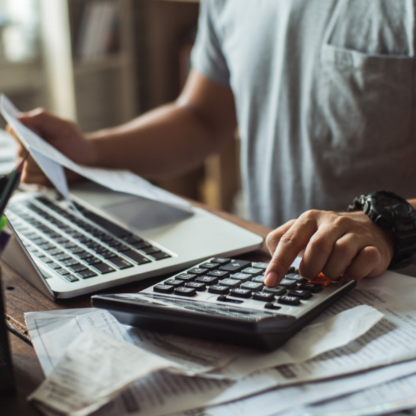 a man typing on a calculator