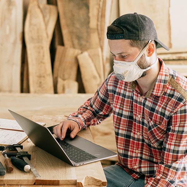 a joiner looking at a laptop